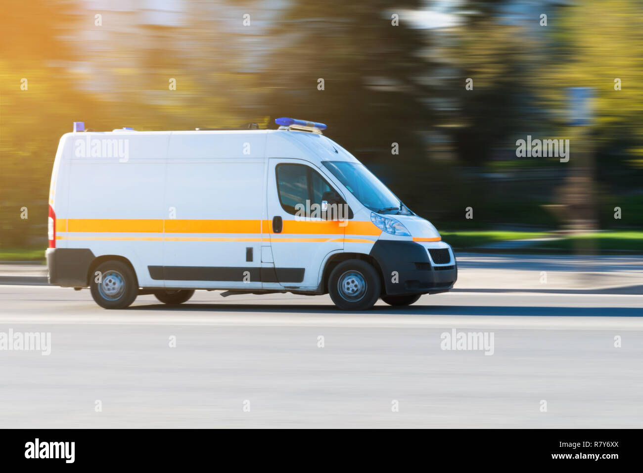 Ambulance in the city on a blurred background. ambulance on emergency call in motion blur. Stock Photo