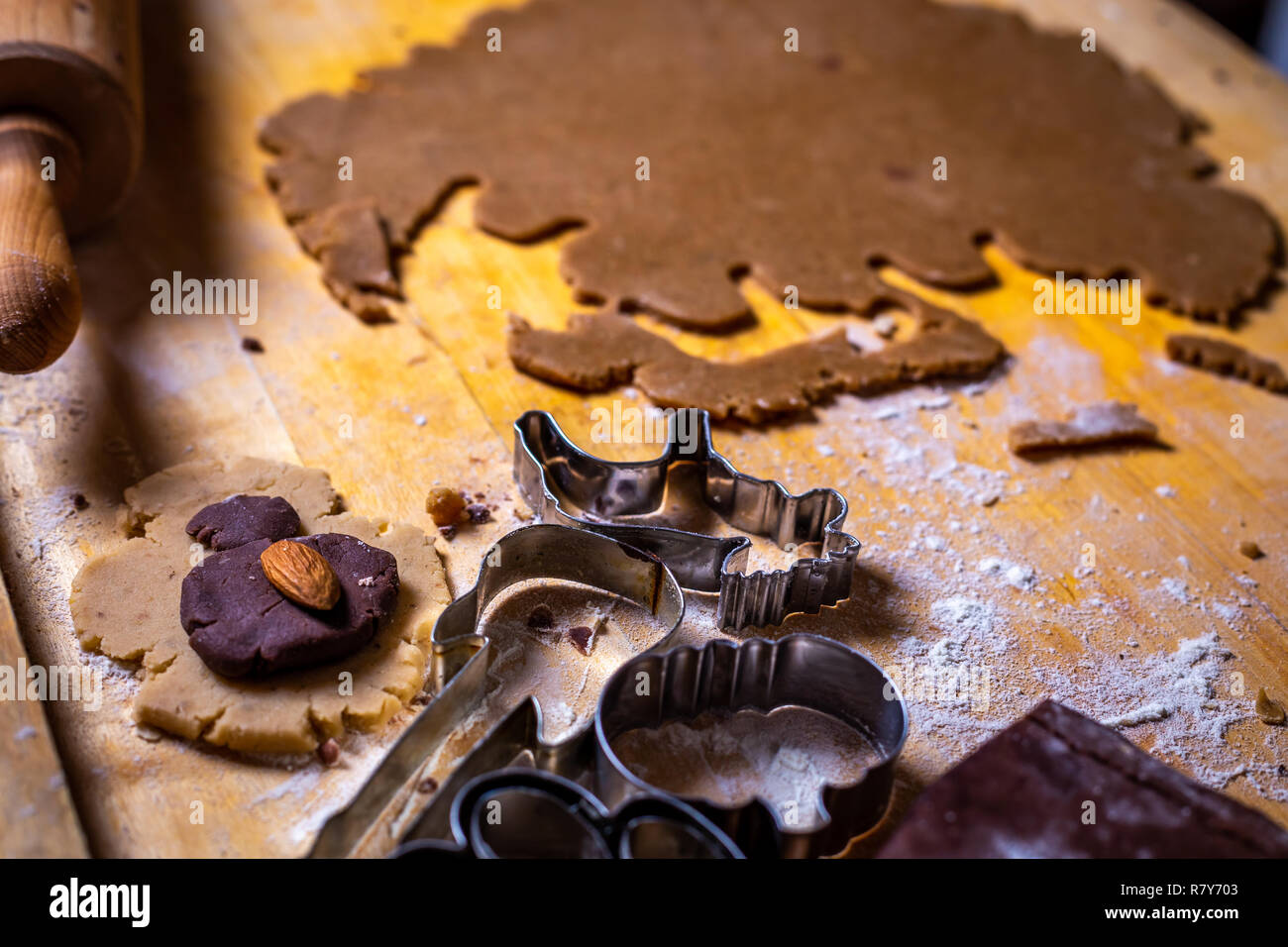 Close up on gingerbread dough and forms, cutters on the wooden table Stock Photo