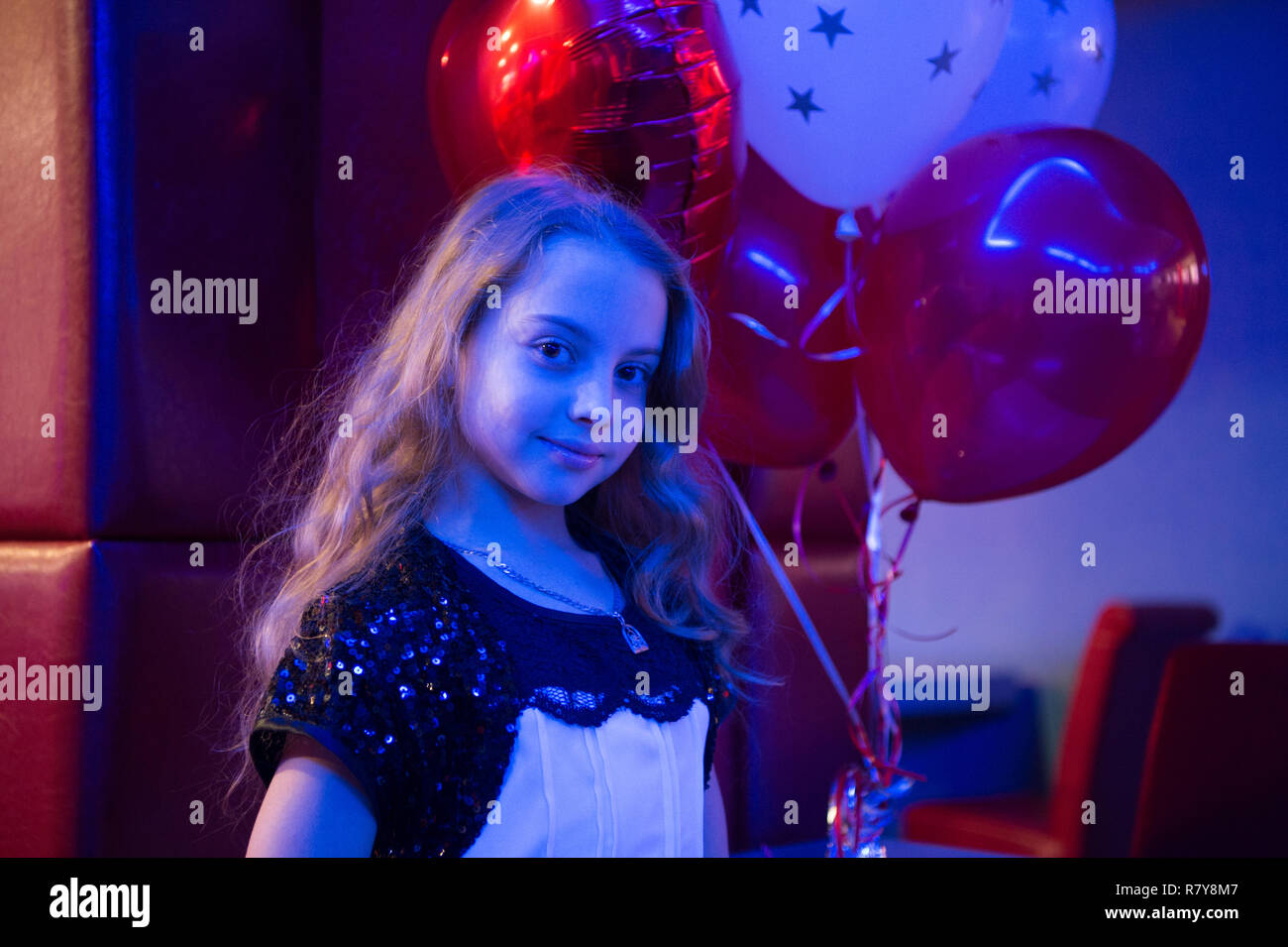 girl cute smiling child hold bunch balloons lighted with blue light girl with balloons celebrate birthday in bowling club birthday party at bowling ideas how to celebrate birthday for teens R7Y8M7