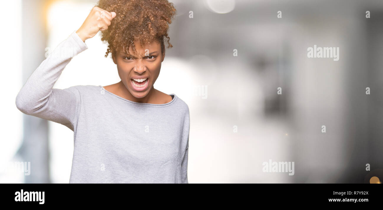 Angry young woman raising hand hi-res stock photography and images - Alamy