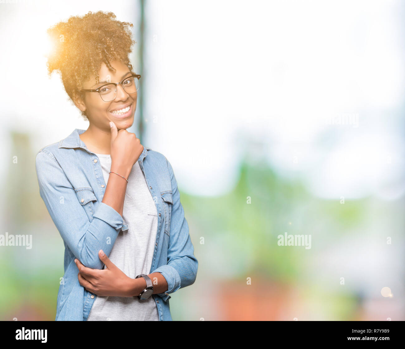 Beautiful young african american woman wearing glasses over isolated ...