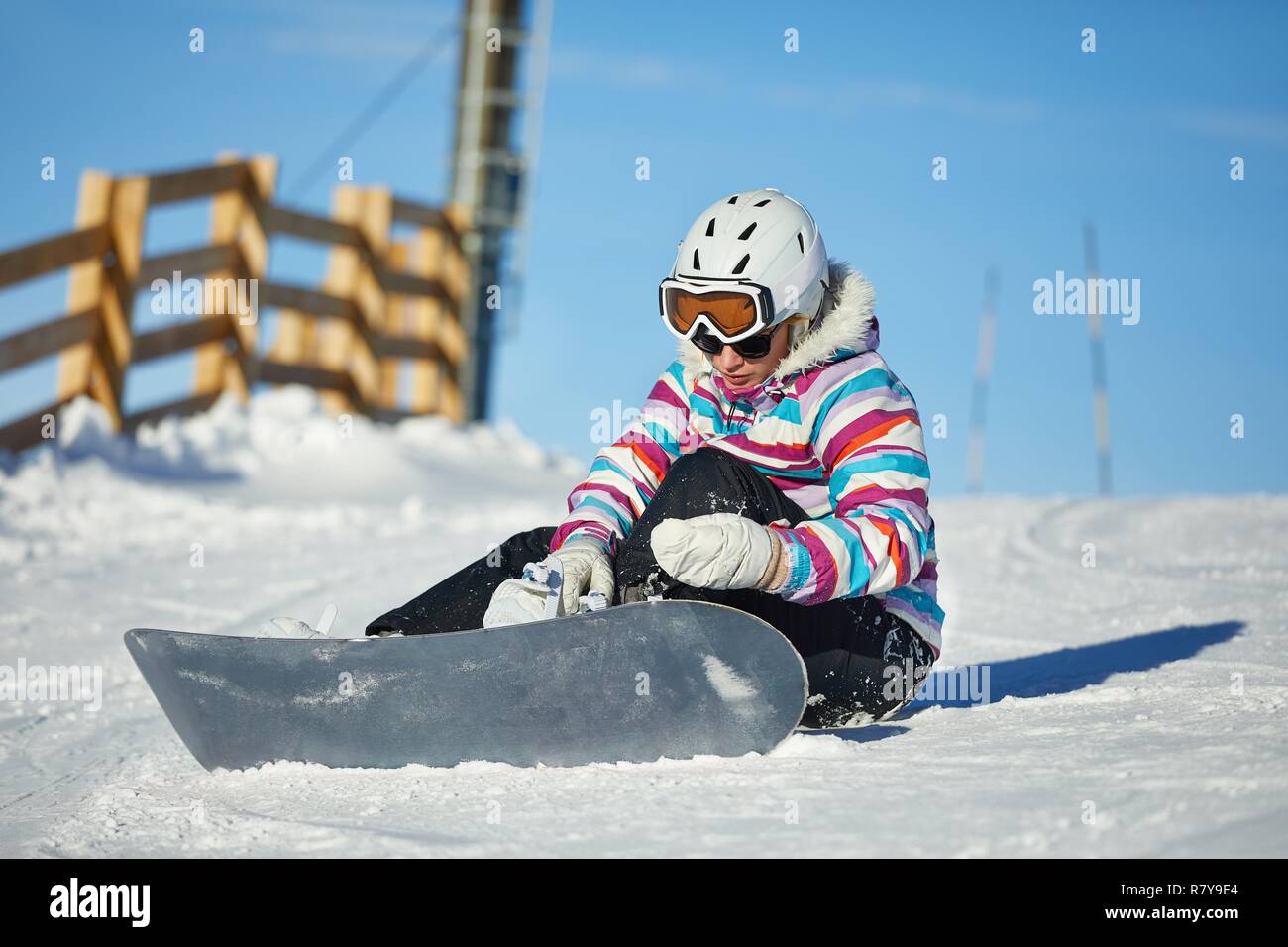 Snowboarder sitting in the snlow Stock Photo