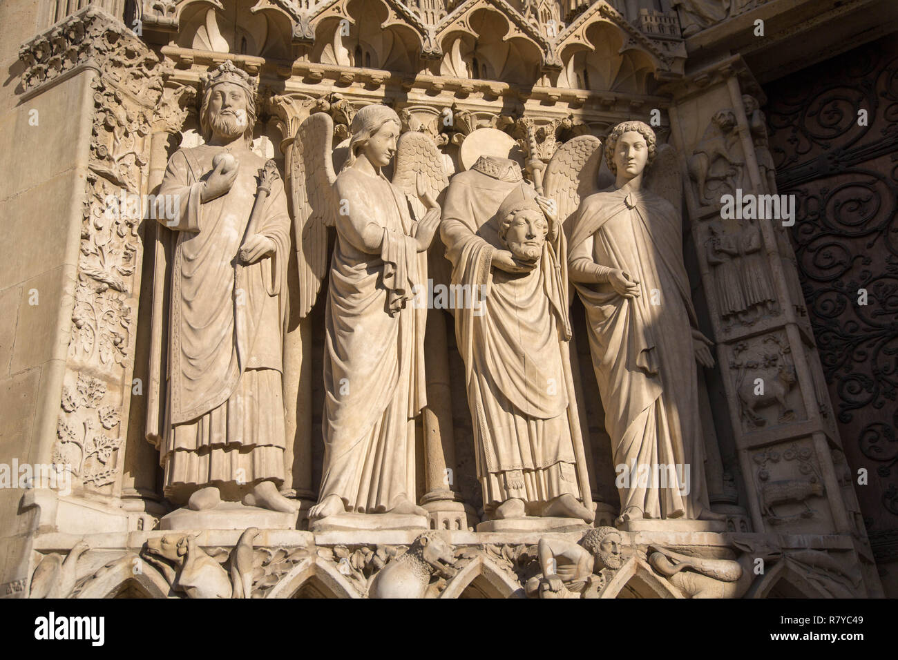 Stone statues at the entrance of NotreDame Cathedral in Paris, France