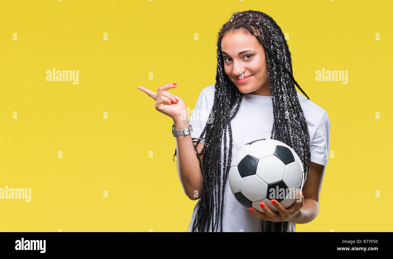 Young Braided Hair African American Girl Holding Soccer Ball Over