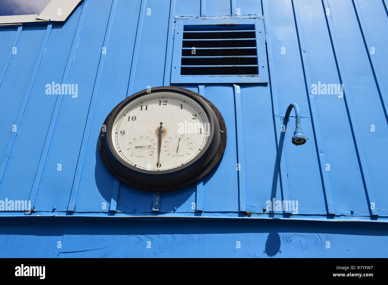 Clock on blue wall Stock Photo