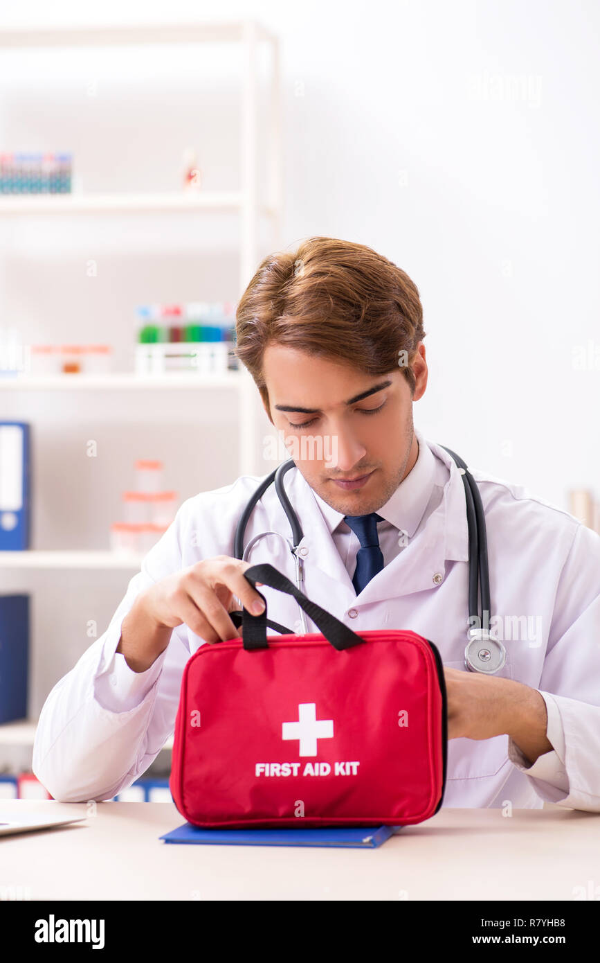 Young doctor with first aid kit in hospital Stock Photo Alamy