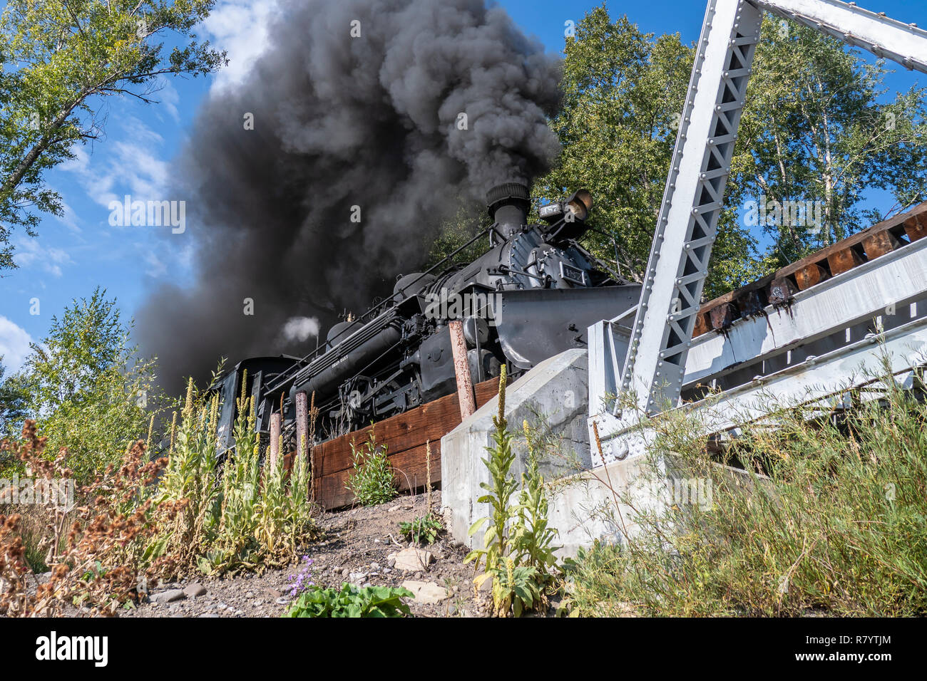 Cumbres & Toltec Scenic Railroad train crosses the Chama River behind the Rio Chama RV Park, Chama, New Mexico. Stock Photo