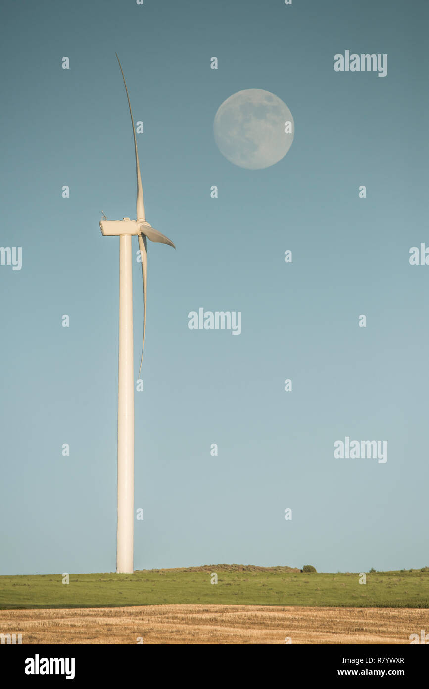 Wind Tower with Full Moon on Sunny Day, Idaho Stock Photo