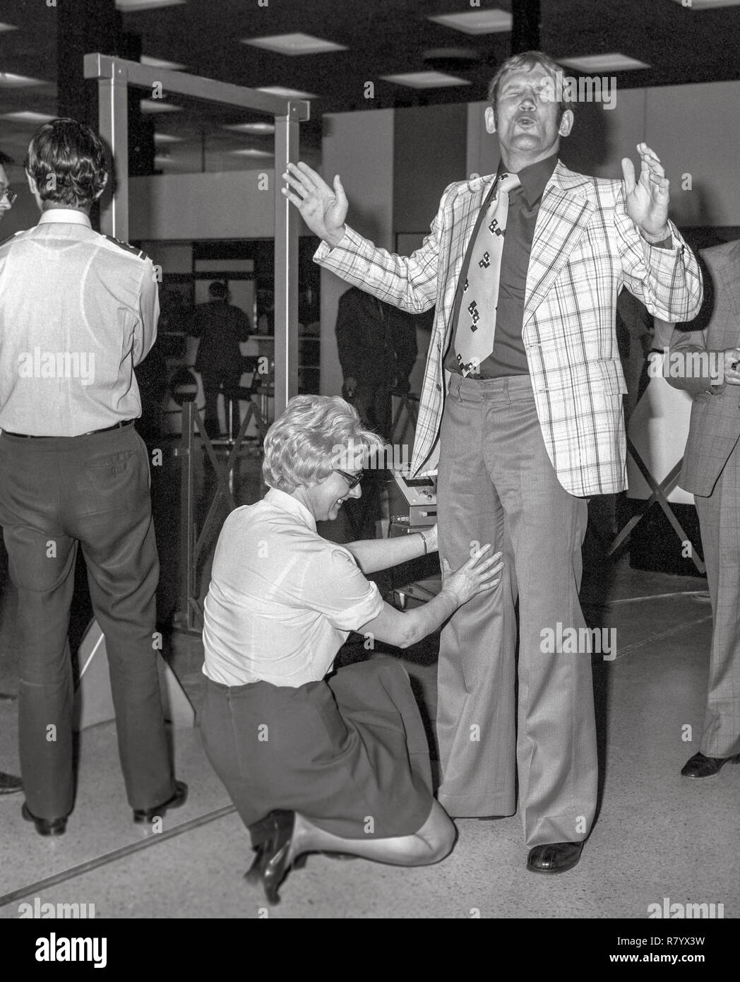 British heavyweight champion Richard Dunn leaving Heathrow Airport for Munich for his world title fight with Muhammad Ali. Picture shows Richard Dunn being  searched by female security guard prior to boarding the aircraft. Stock Photo