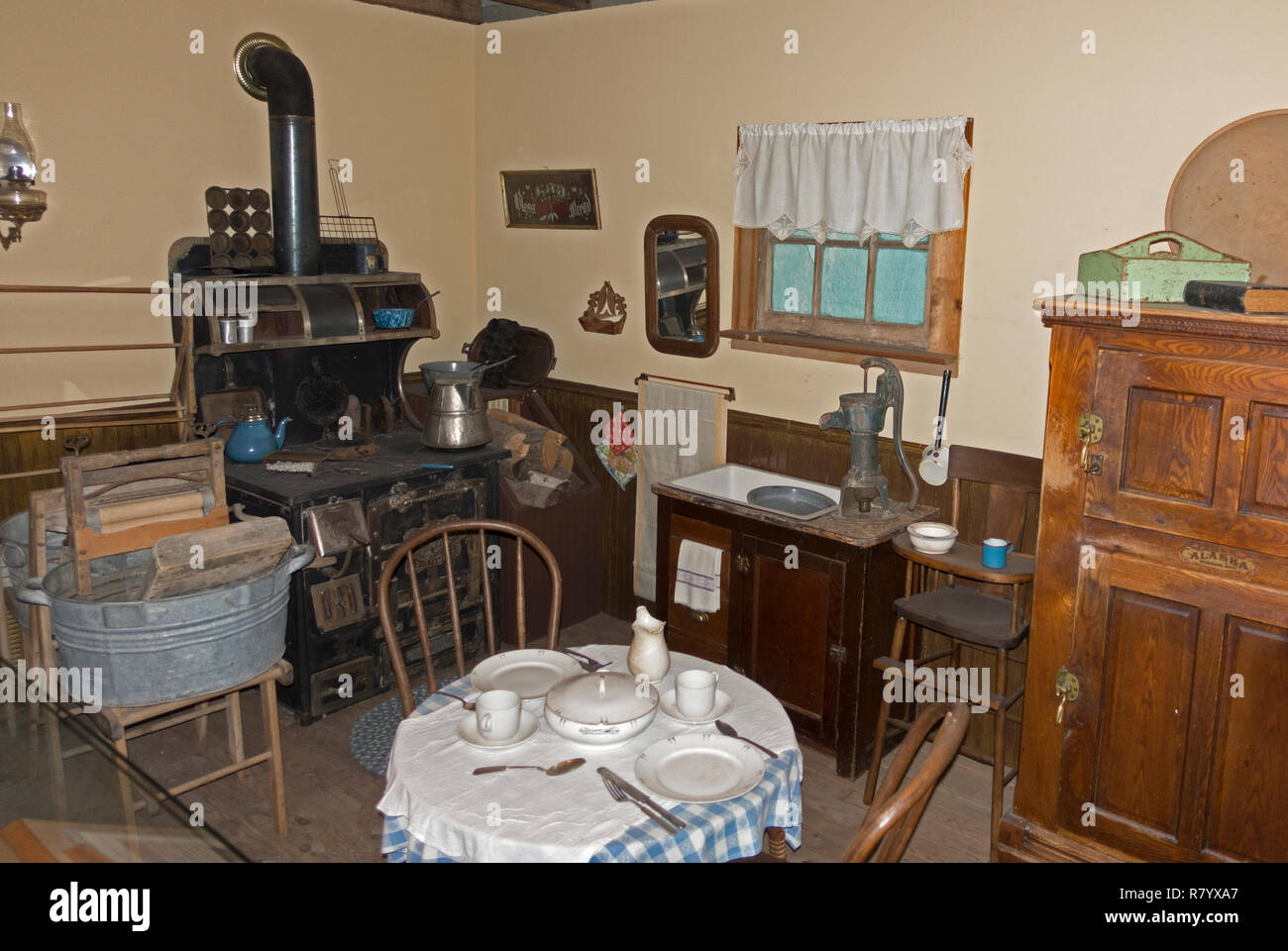 Historical kitchen with wood burning stove, clothes wringer wash tub displayed at Otter Tail County Historical Museum. Fergus Falls Minnesota MN USA Stock Photo