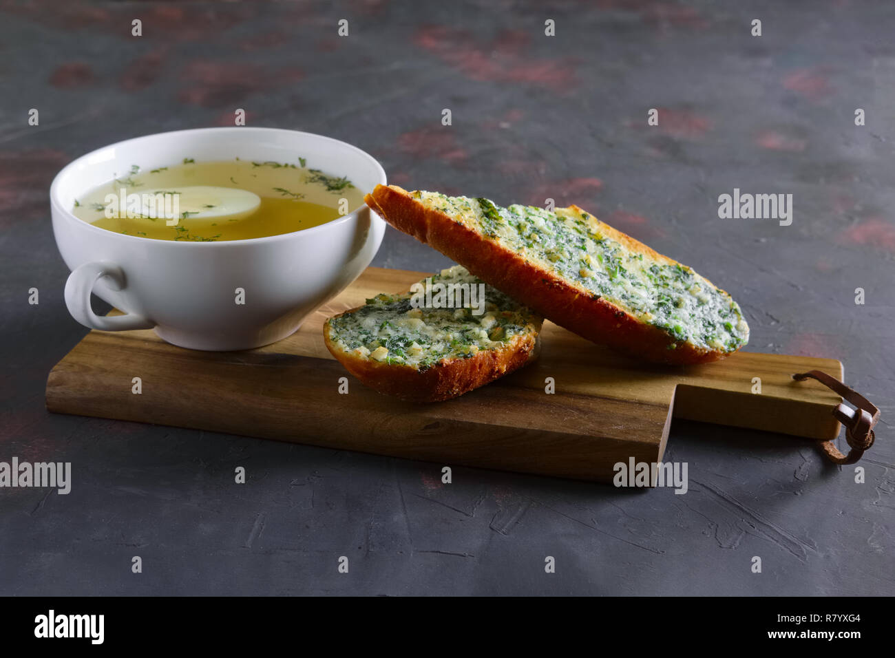 Clear chicken broth with egg served with toasts Stock Photo Alamy