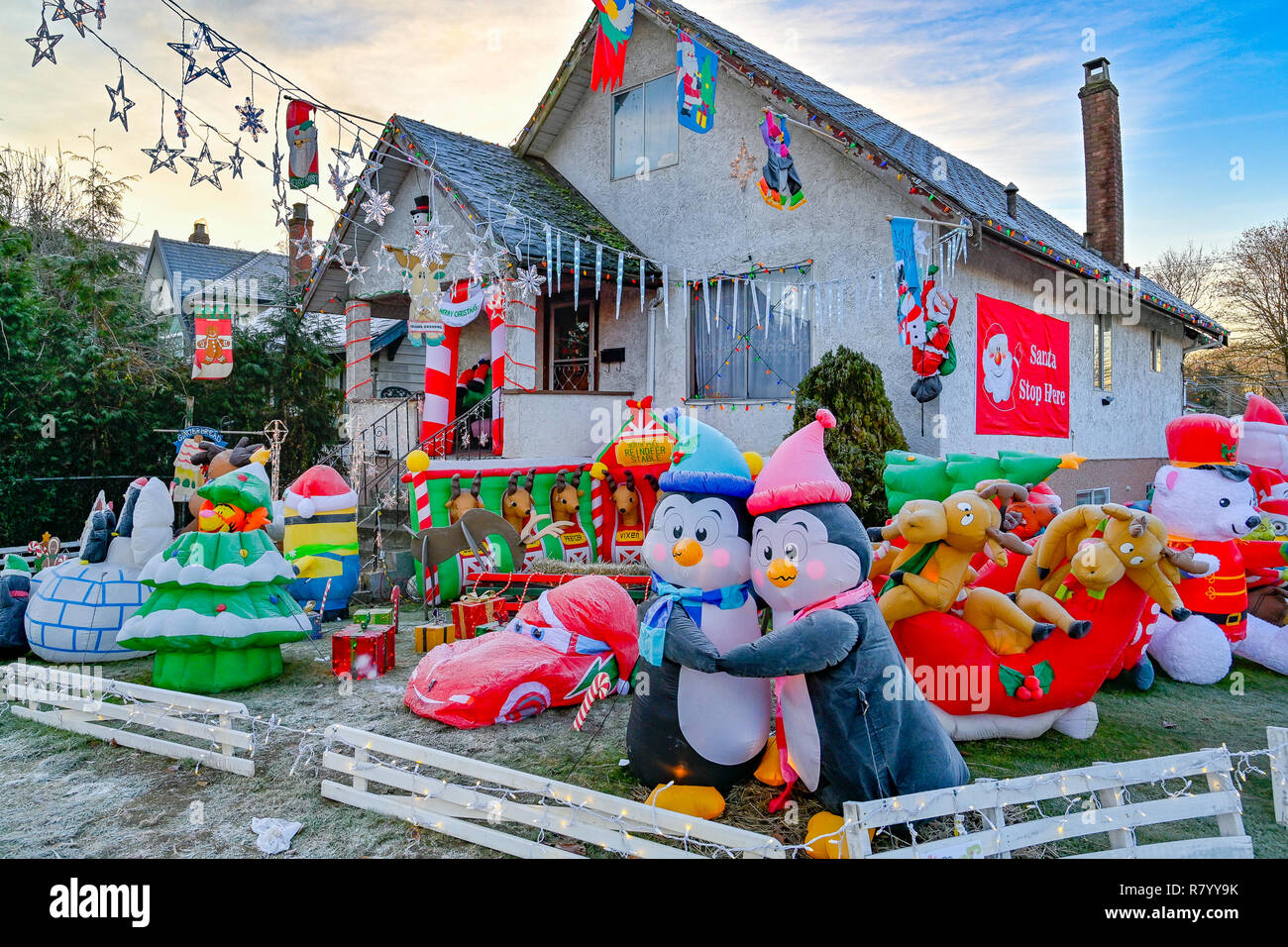 Front lawn, Christmas dislpay, inflatable plastic, kitsch, penguins, hugging Stock Photo