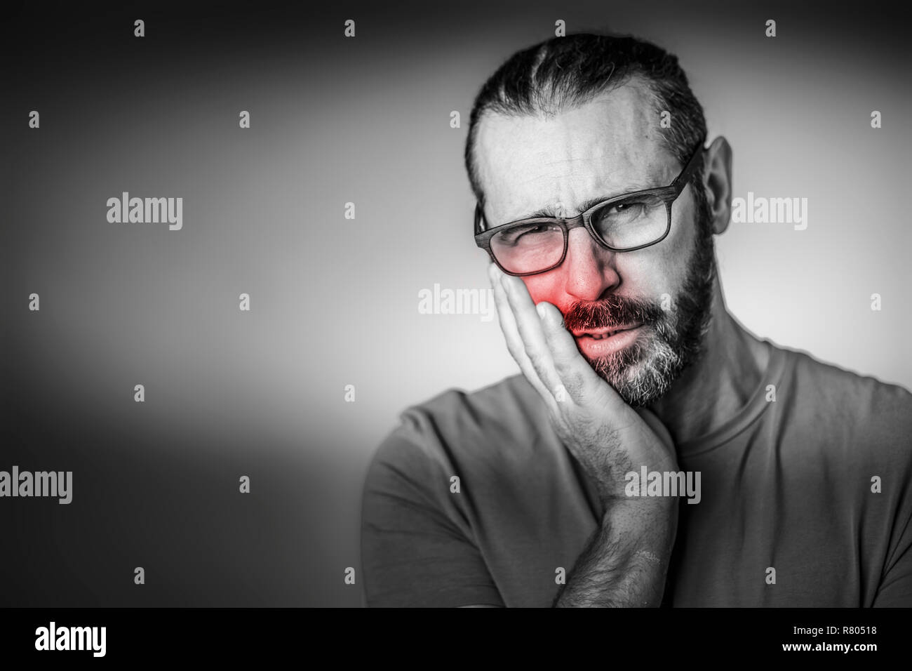portrait of man with glasses and toothache Stock Photo