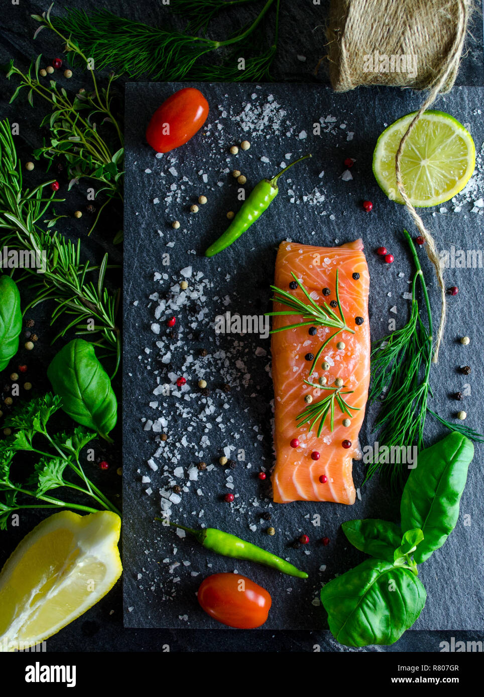 Salmon fillet with herbs on slate Stock Photo - Alamy