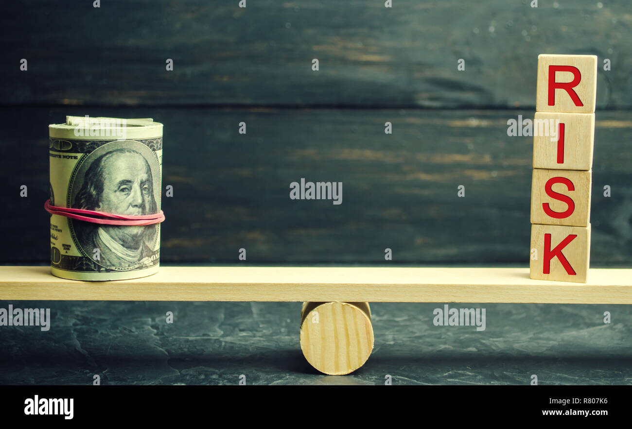 Dollars and the inscription risk are on the scales. The concept of financial and economic risk. Unreliable investment. Unpaid loan. Financial risk man Stock Photo