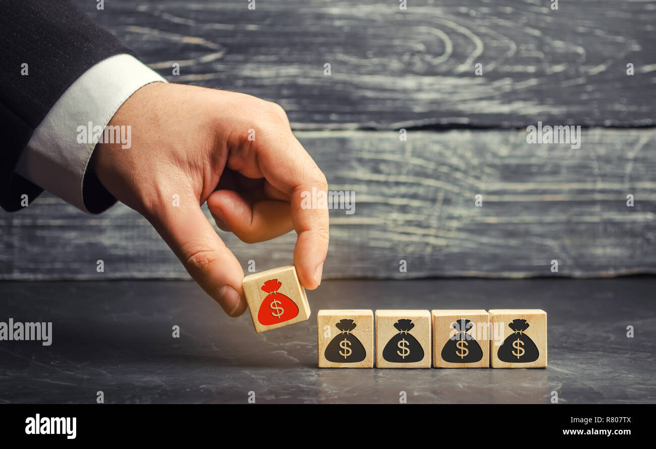 businessman removes a cube with a picture of dollars. financial and economic crisis. capital outflow. sabotage of the economy. bankruptcy. pressure on Stock Photo