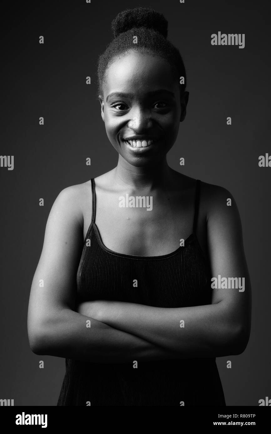 Black and white portrait of young beautiful African woman smiling Stock Photo