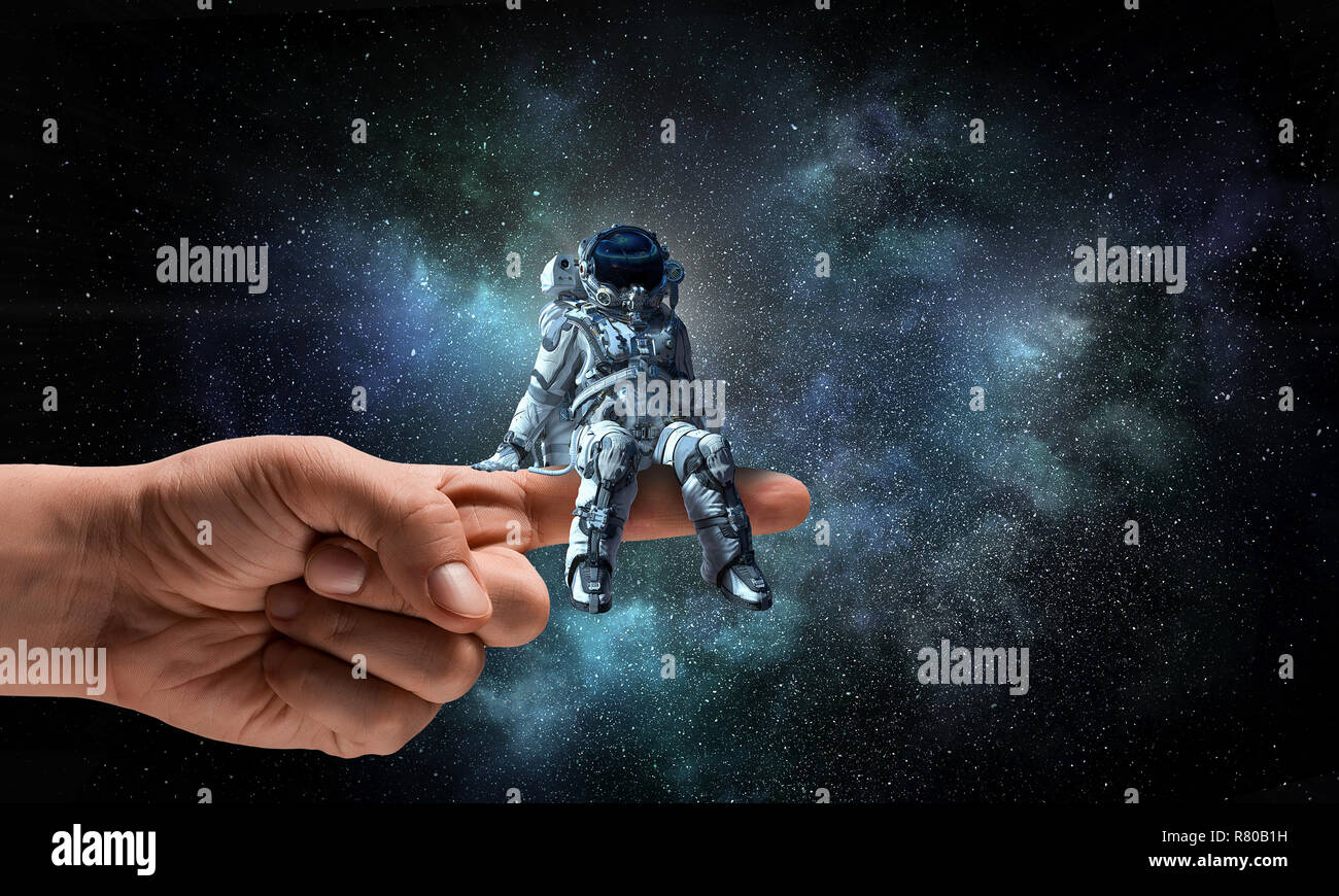 Spaceman on finger. Mixed media Stock Photo - Alamy