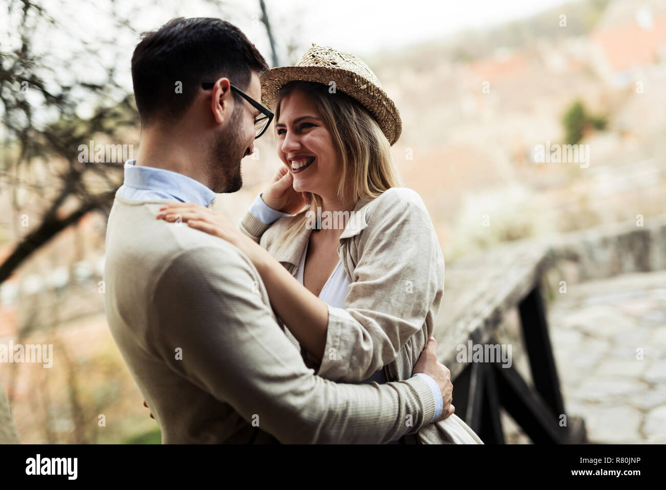 Happy young couple in love hugging and smiling outdoor Stock Photo - Alamy