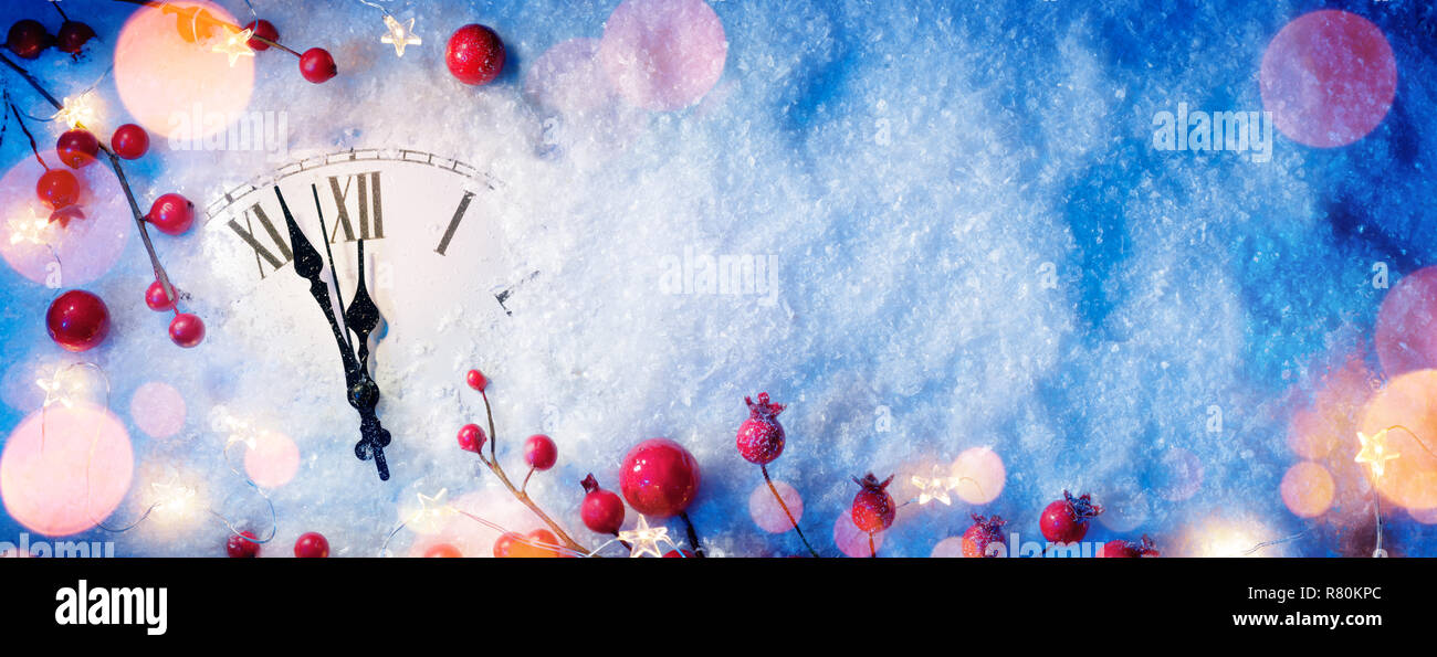 Waiting Midnight - Happy New Year With Clock And Berries On Snow Stock Photo