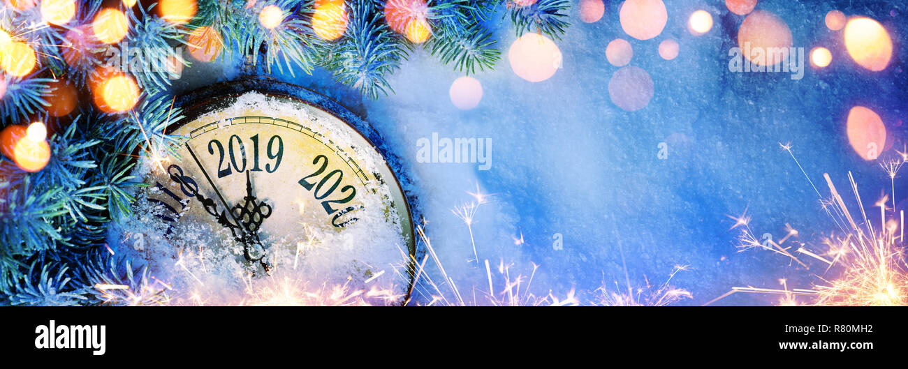 New Year 2019 - Celebration With Dial Clock On Snow And Lights Stock Photo