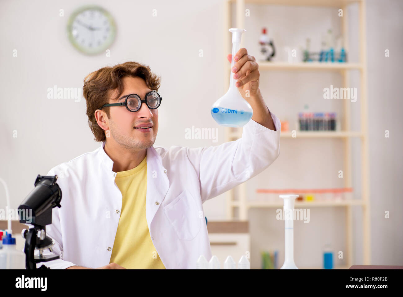 Funny crazy chemist doing experiments and tests Stock Photo