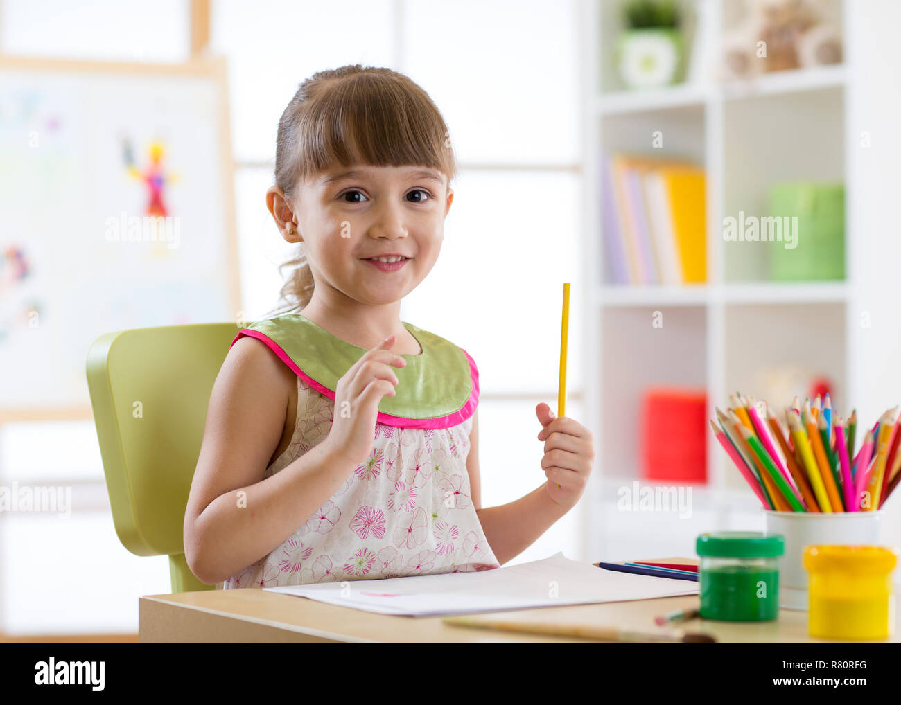 Preschooler child girl drawing and coloring by pencils Stock Photo - Alamy