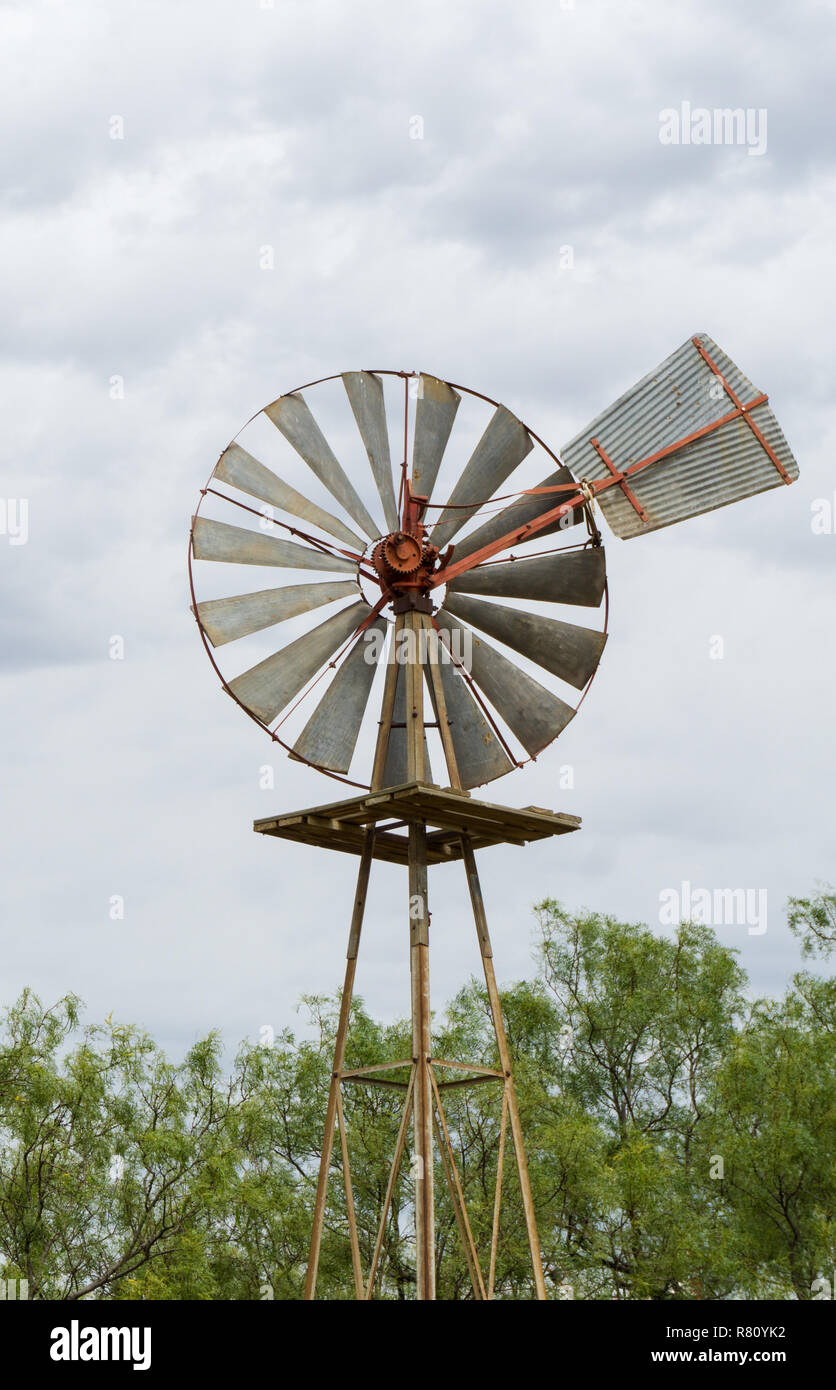 single old historic wind wheel or wind pump made of wood and metal up close Stock Photo