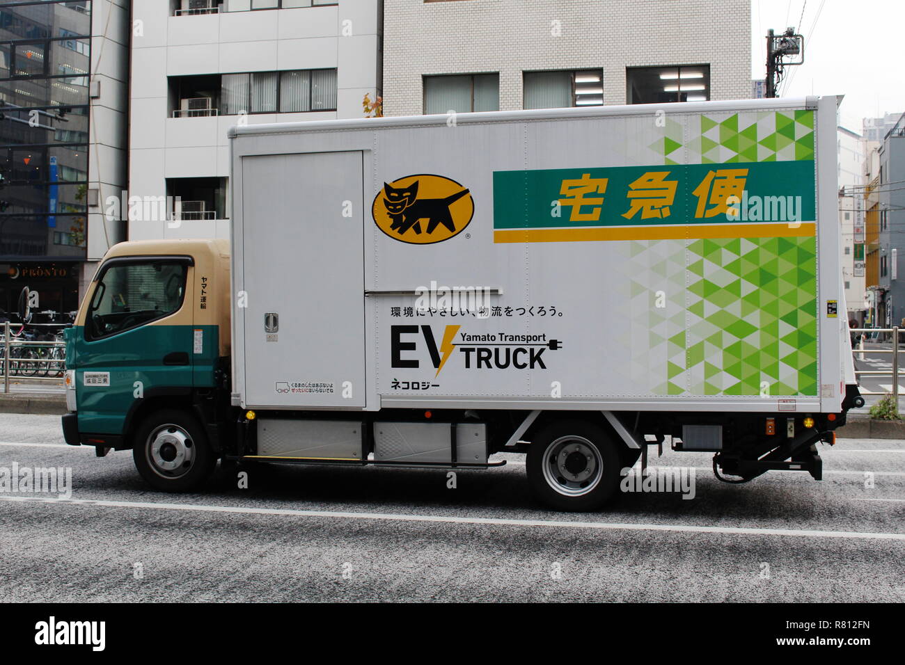 A Yamato Transport Company (Kuroneko) Mitsubishi Fuso Truck and Bus Corporation EV truck in traffic in a street in Kayabacho. Stock Photo