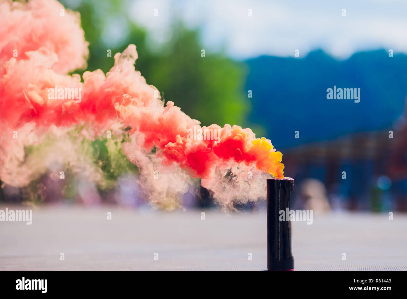 colorful red smoke bombs in action Stock Photo - Alamy