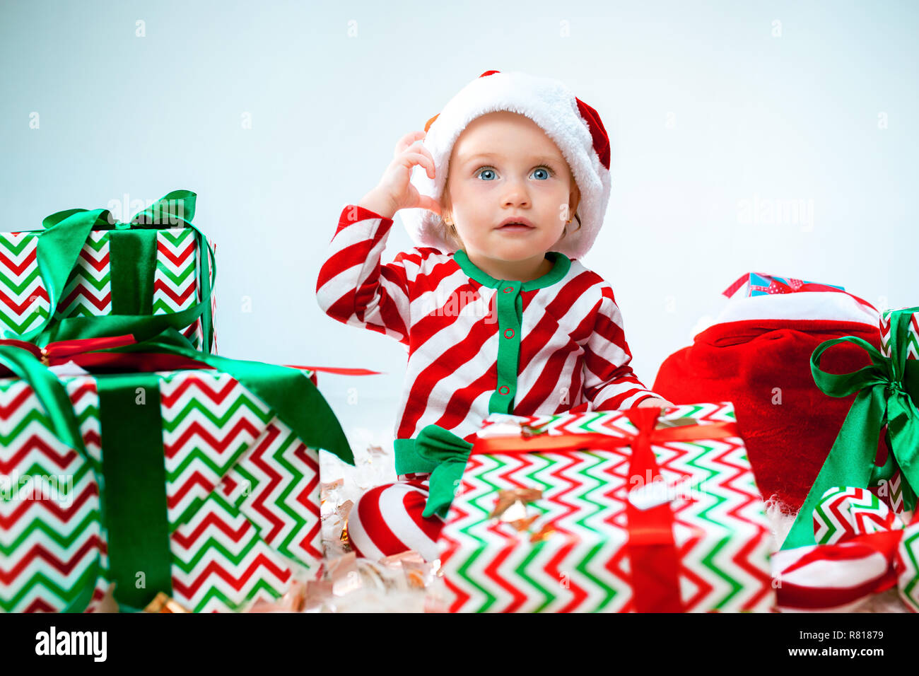Cute Baby Girl 1 Year Old Wearing Santa Hat Posing Over Christmas