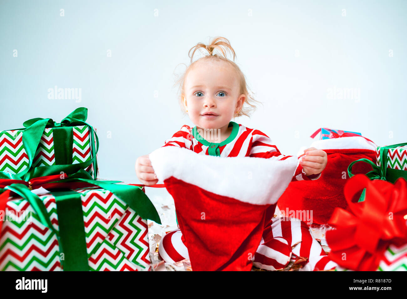Cute Baby Girl 1 Year Old Wearing Santa Hat Posing Over Christmas