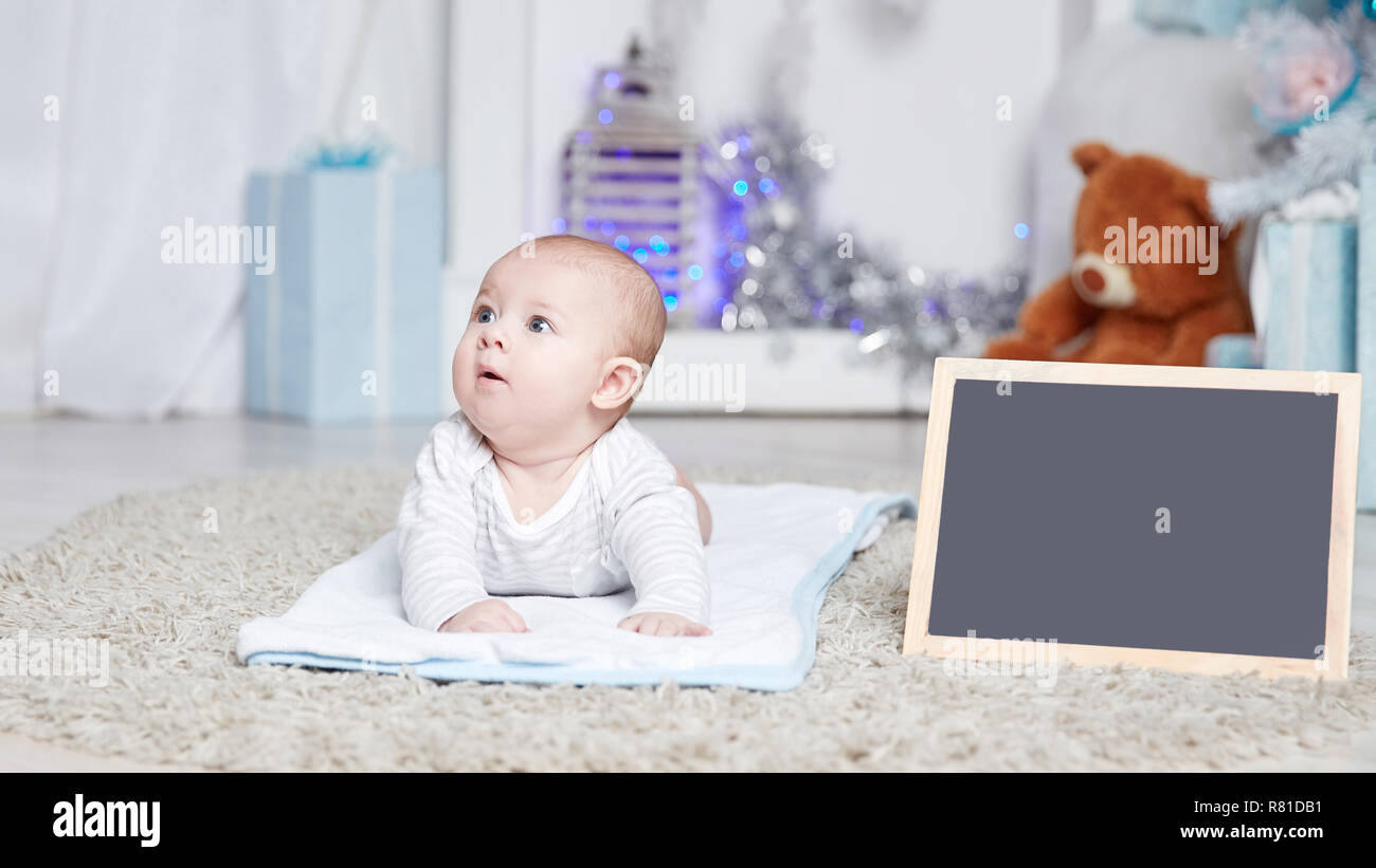 pretty baby in a cozy living room on Christmas eve Stock Photo