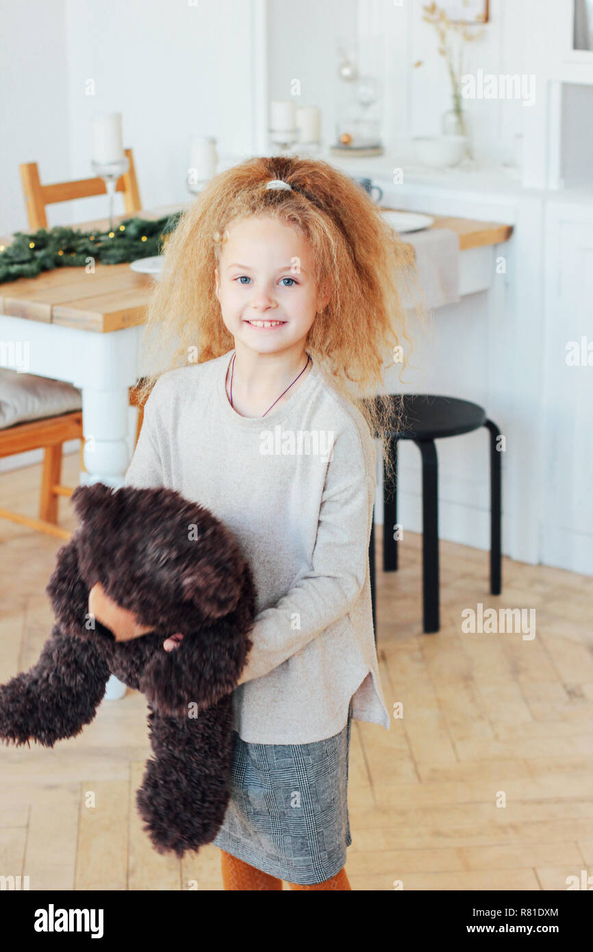 Beautiful 8 Year Old Girl With Bear Toy In Christmas Decor Room