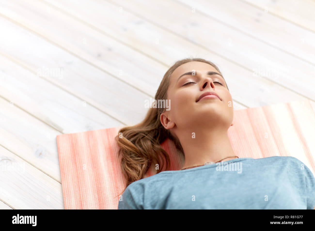woman doing yoga corpse pose at studio Stock Photo