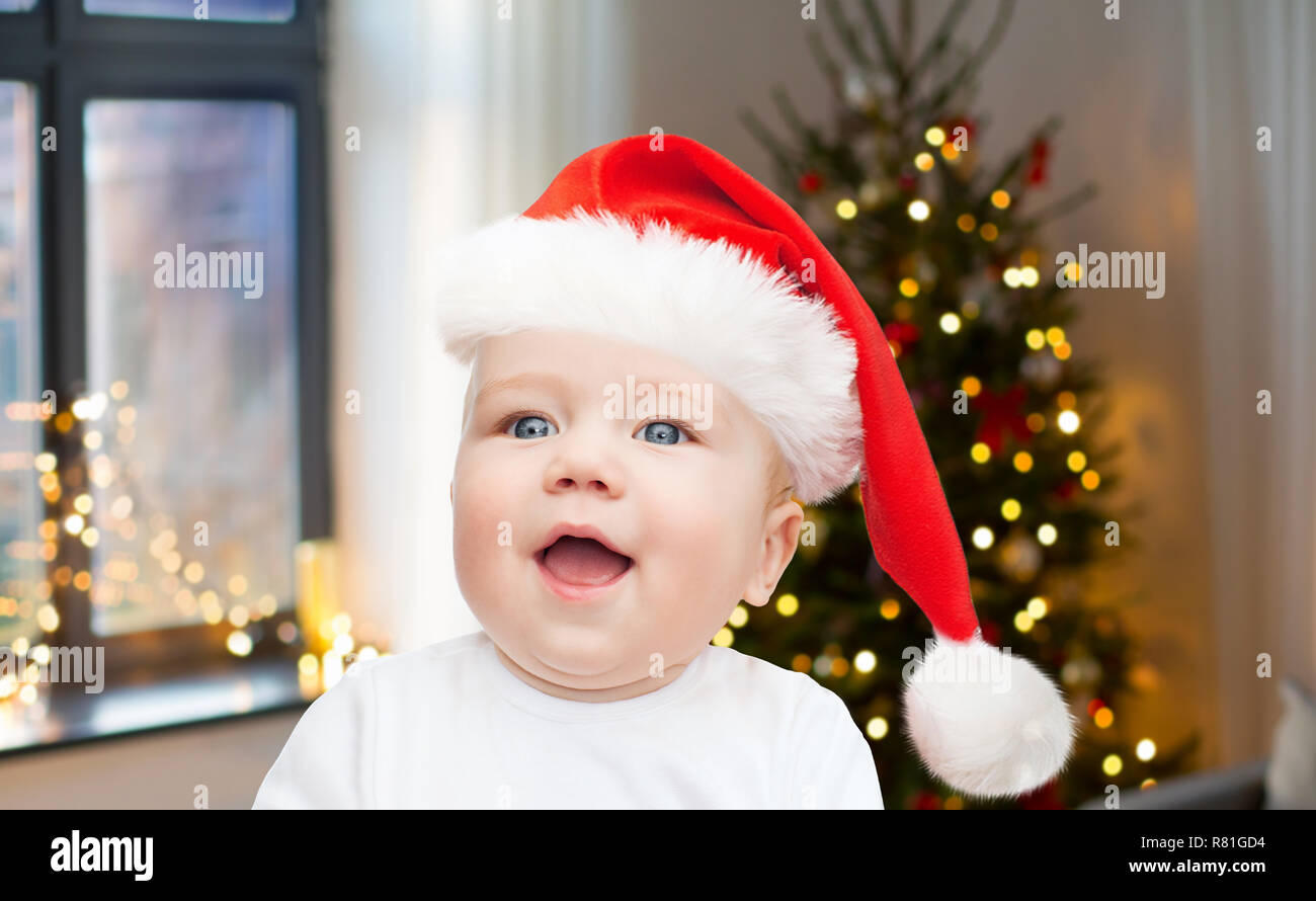 close up of little baby in santa hat on christmas Stock Photo