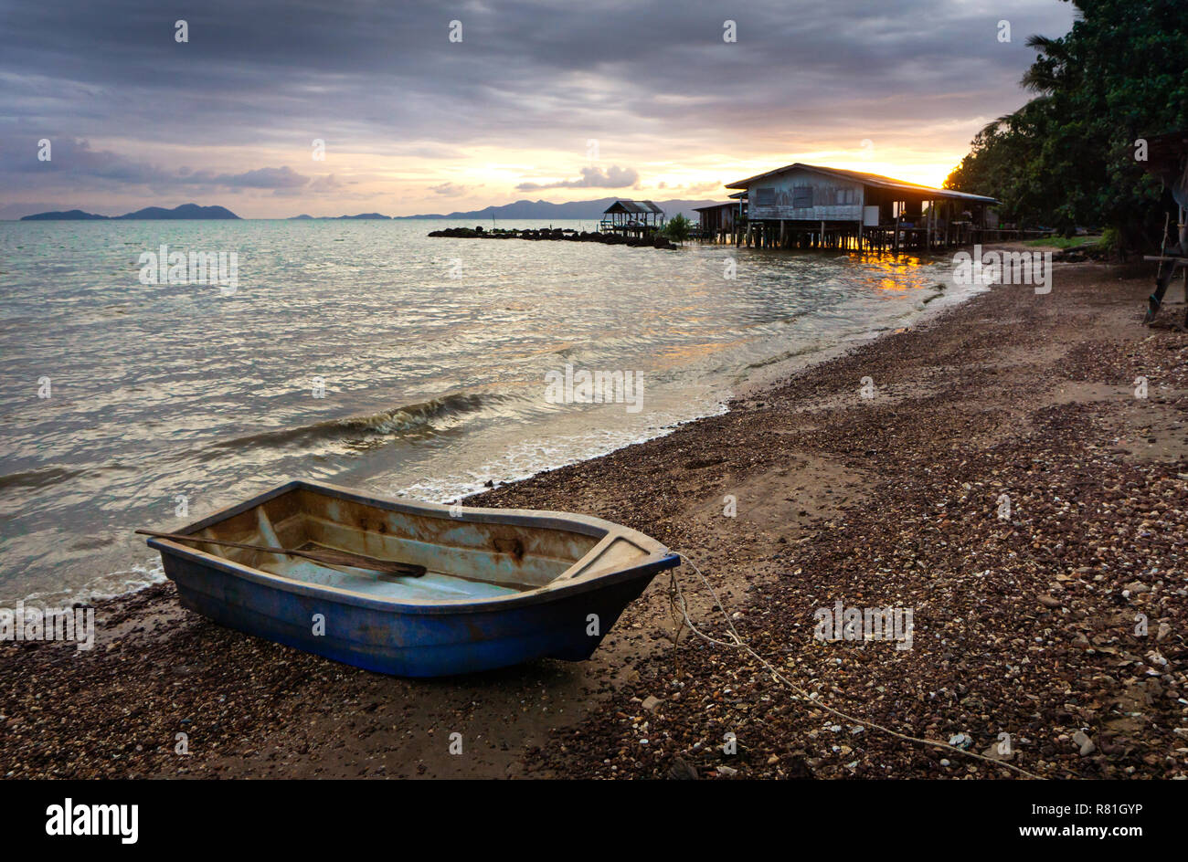 Fishing boat parked in the beach at sunset time in Thailand. Stock Photo