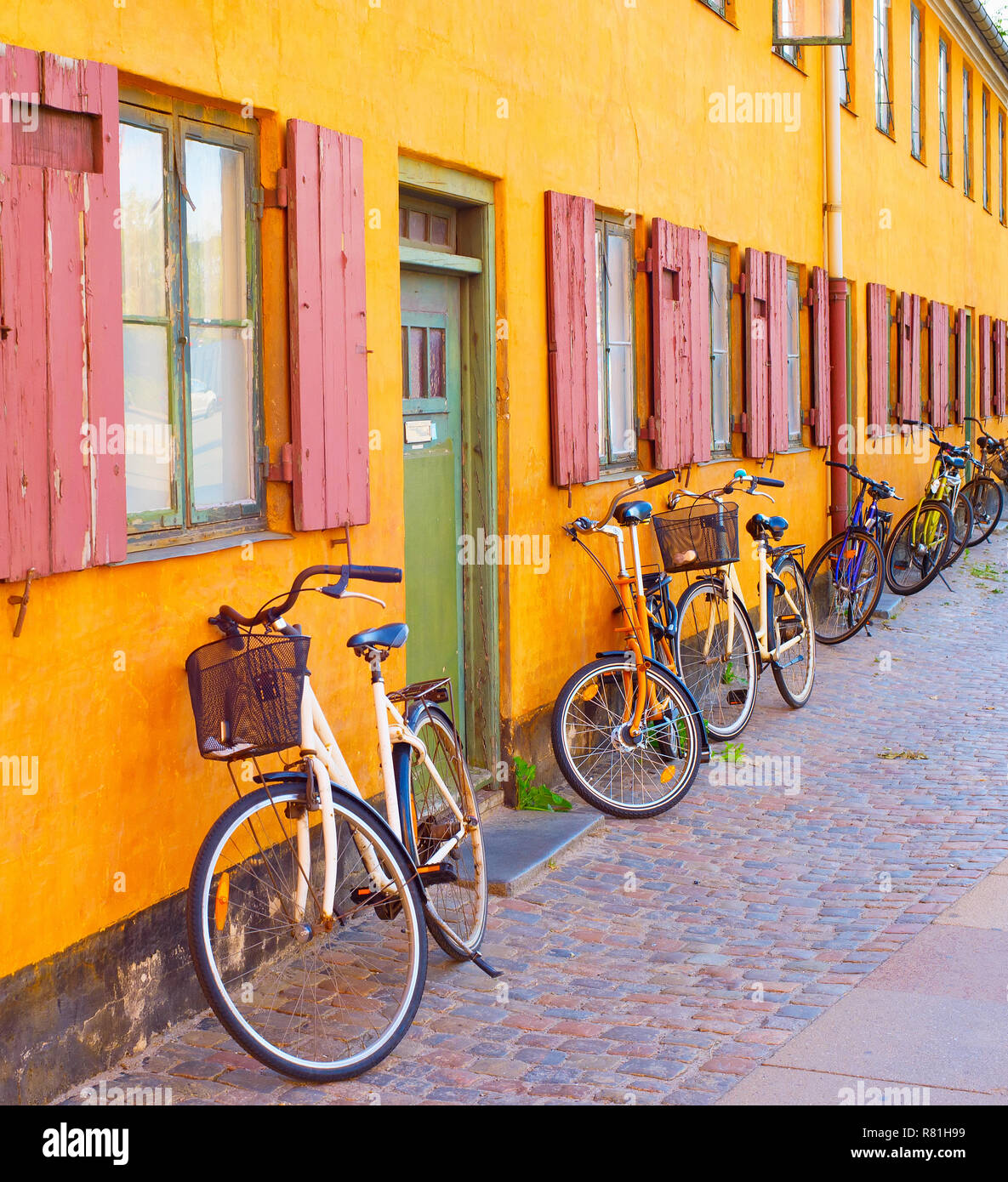 Bicycles along the old building wall. Copenhagen, Denmark Stock Photo