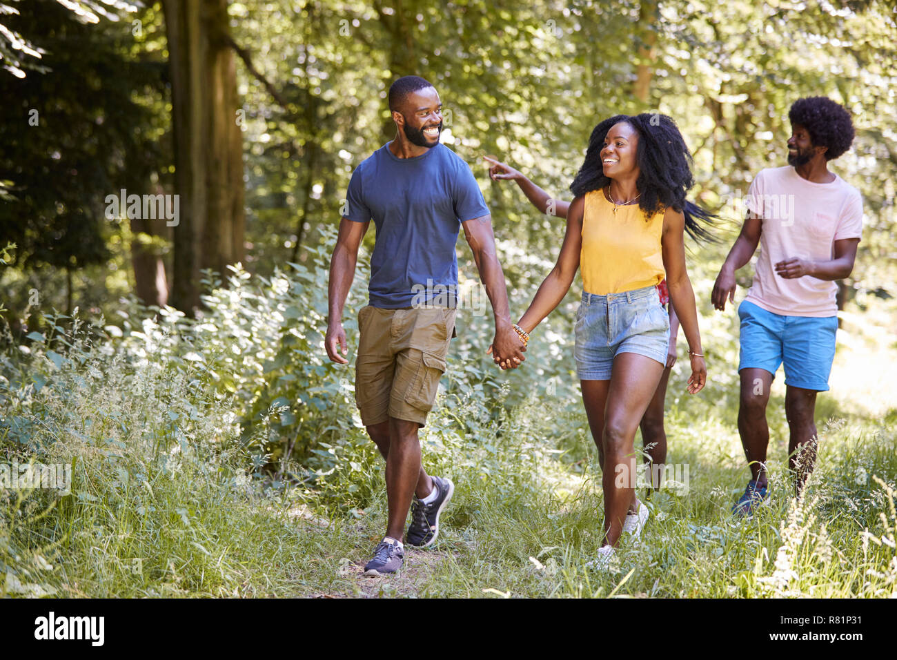 Two black couples walking together in woods Stock Photo