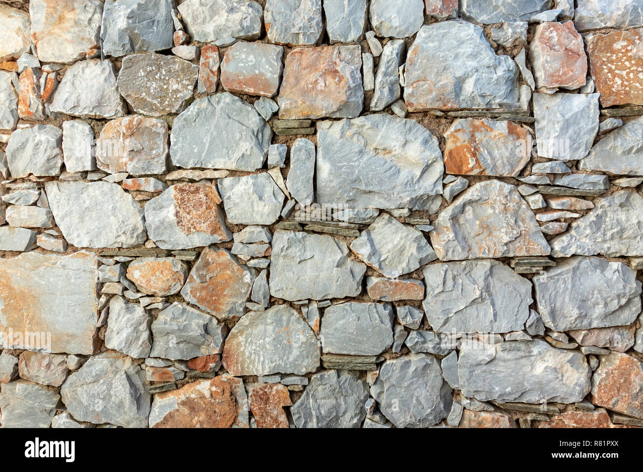 Stone wall fence rustic texture background in the back yard outside