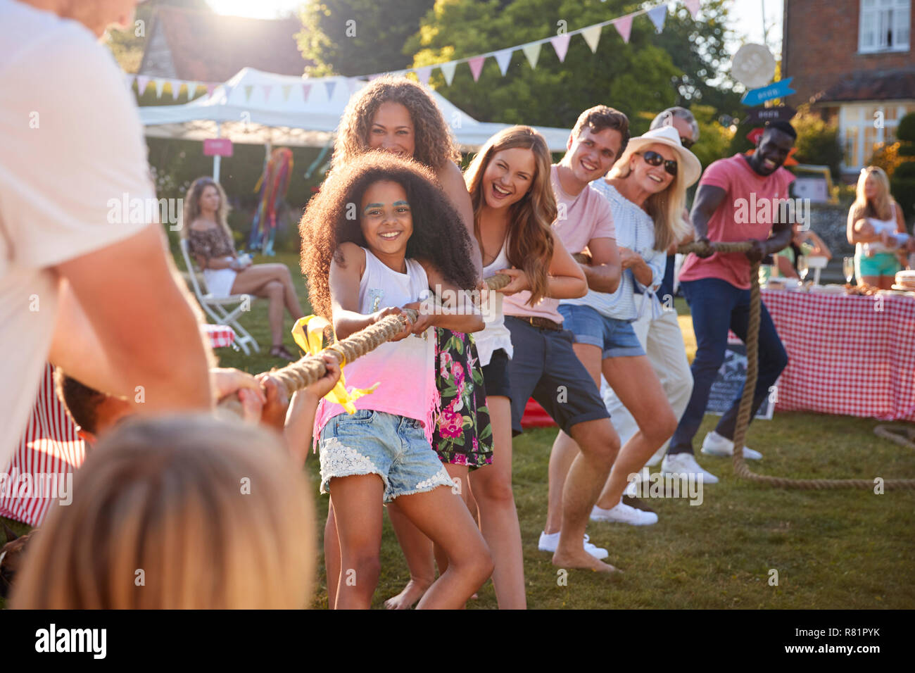 Game Of Tug Of War At Summer Garden Fete Stock Photo