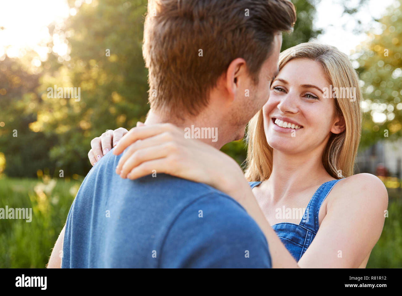Loving Couple Hugging Outdoors In Summer Park Stock Photo