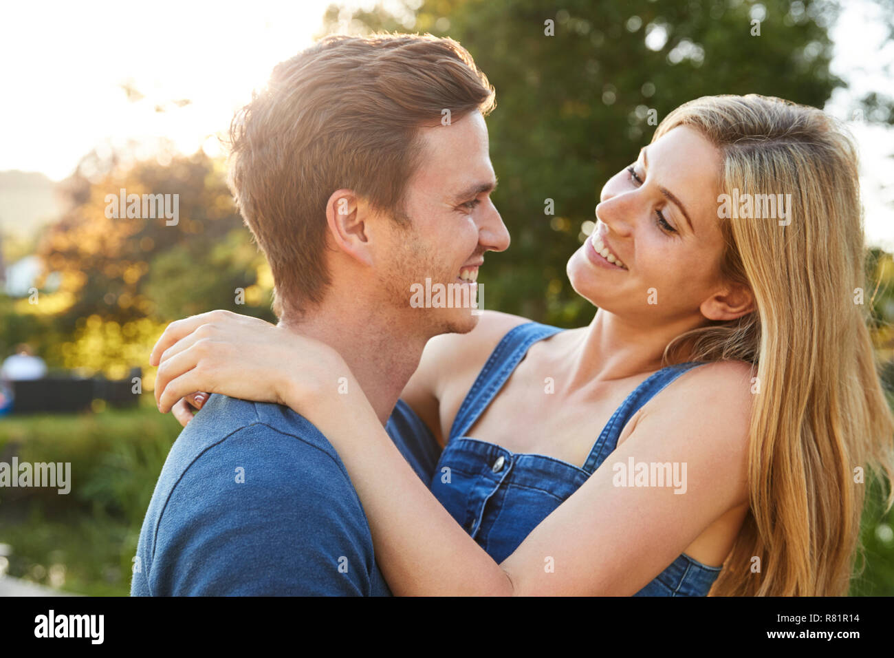 Loving Couple Hugging Outdoors In Summer Park Stock Photo