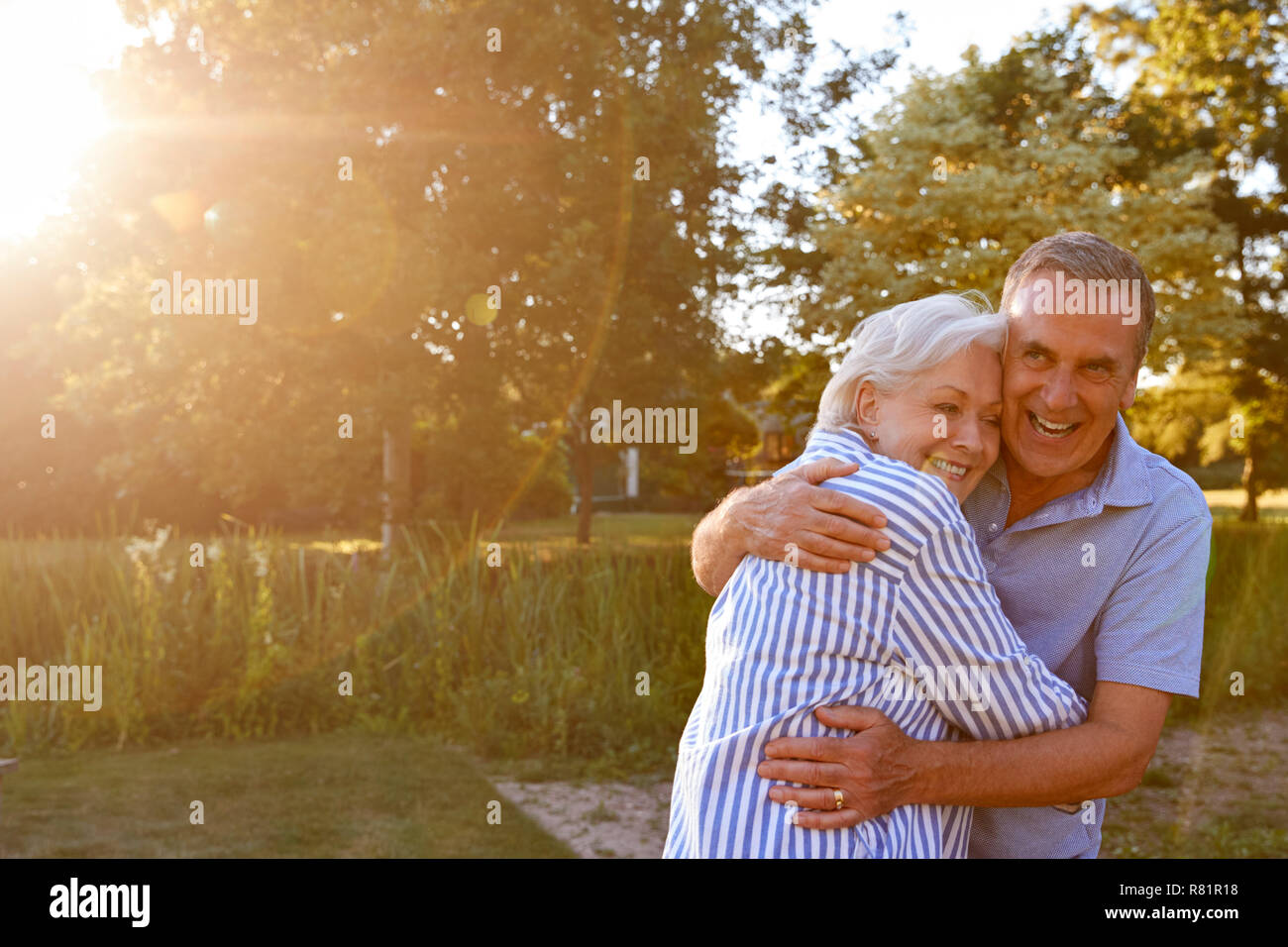Portrait Of Loving Senior Couple Hugging Outdoors In Summer Park ...