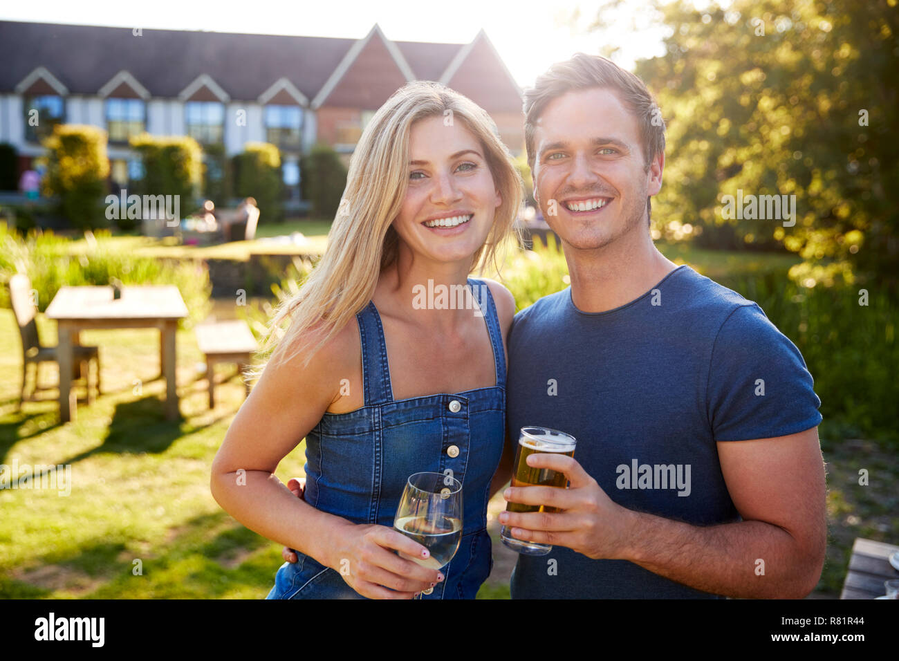 Portrait Of Couple Enjoying Outdoor Summer Drink At Pub Stock Photo