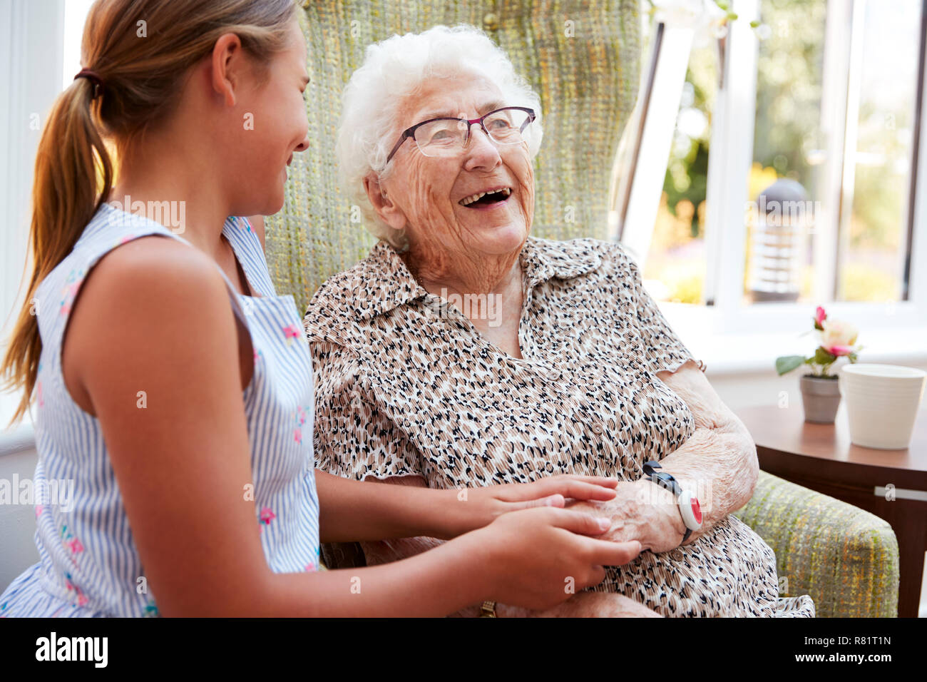 Granddaughter Visiting Grandmother In Lounge Of Retirement Home Stock Photo