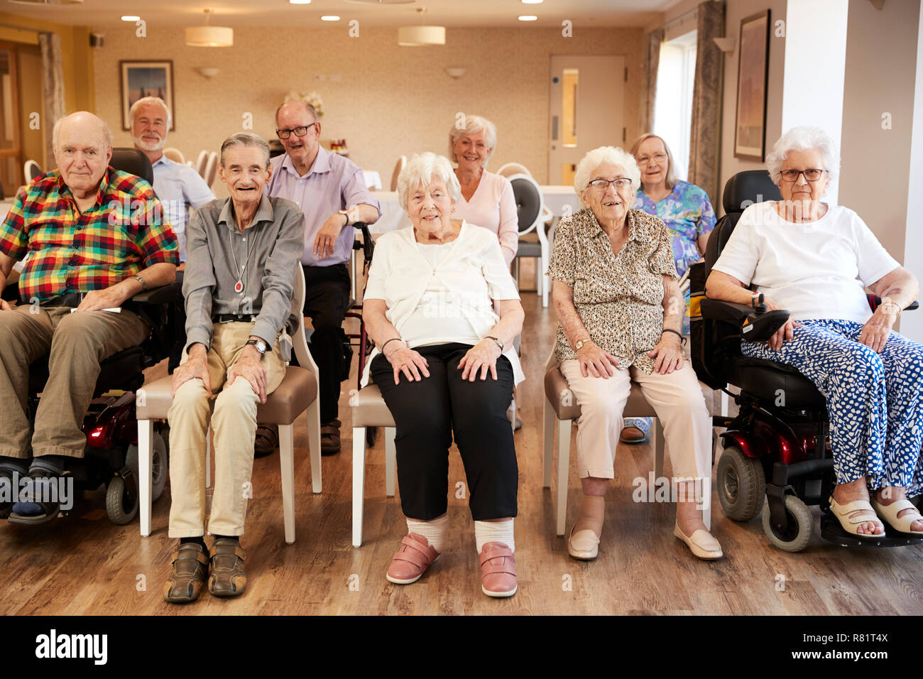 Portrait Of Senior Residents Of Retirement Home Sitting In Lounge Stock