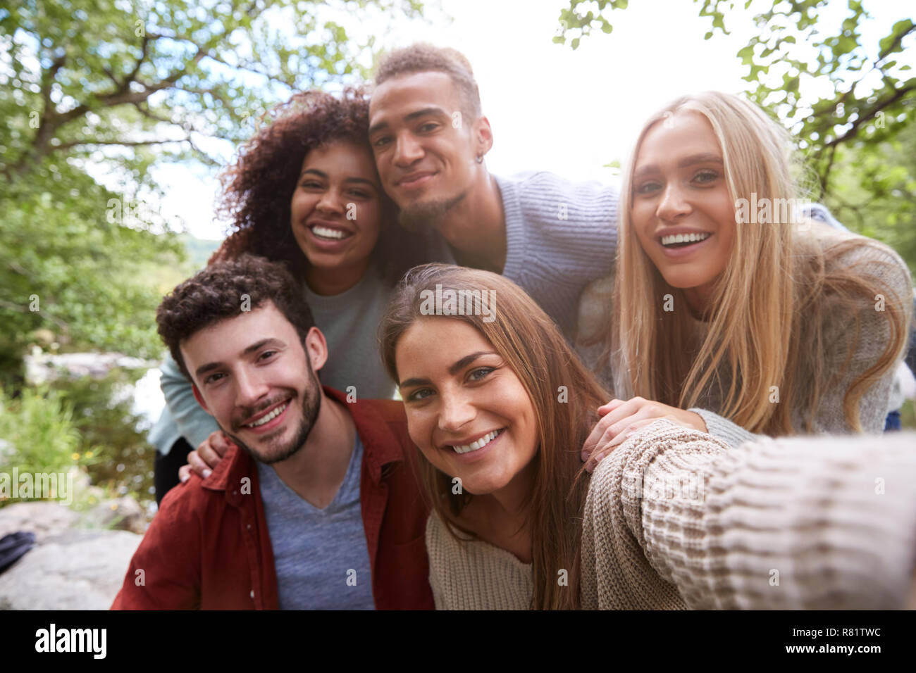 three happy friends are being funny and playful and posing for a group  photo. Photoshoot with family members Stock Photo - Alamy