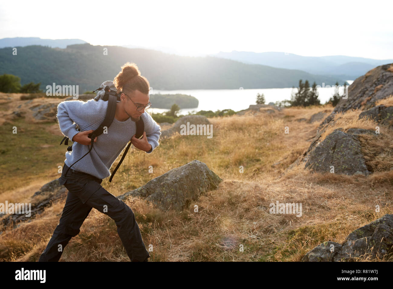 A young mixed race man running alone in the mountains Stock Photo
