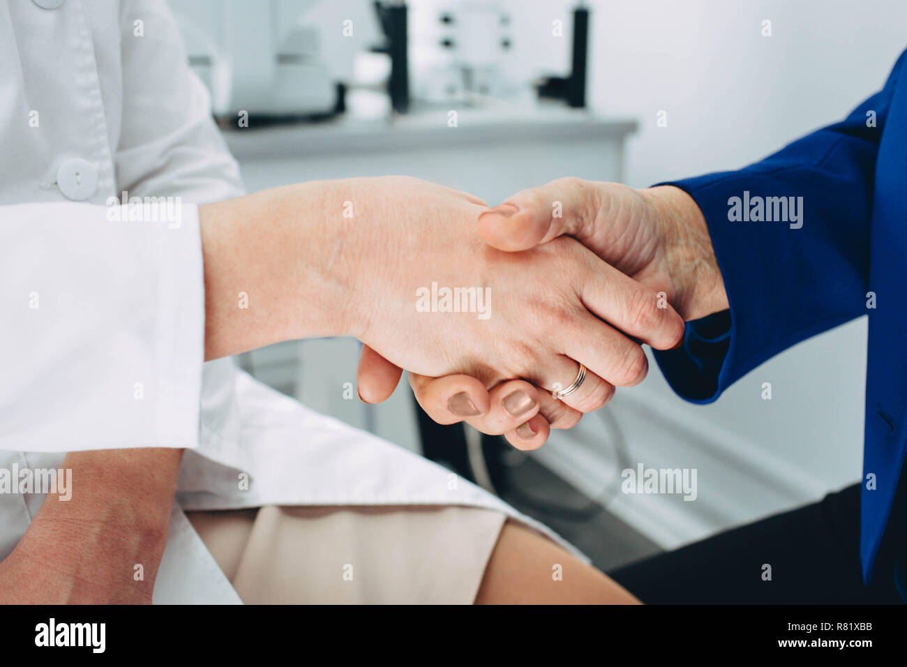 medical trust and support. Handshake doctor and aged patient Stock